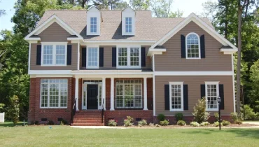 Three story hardiboard and brick home.
