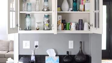 Kitchen cupboard filled with glassware.